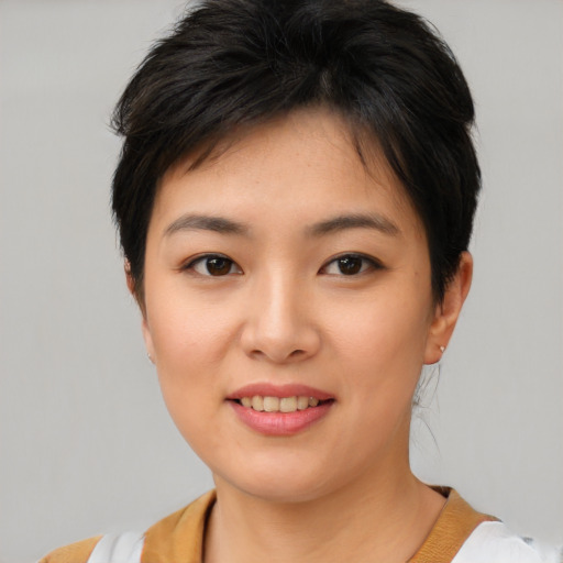 Joyful asian young-adult female with short  brown hair and brown eyes