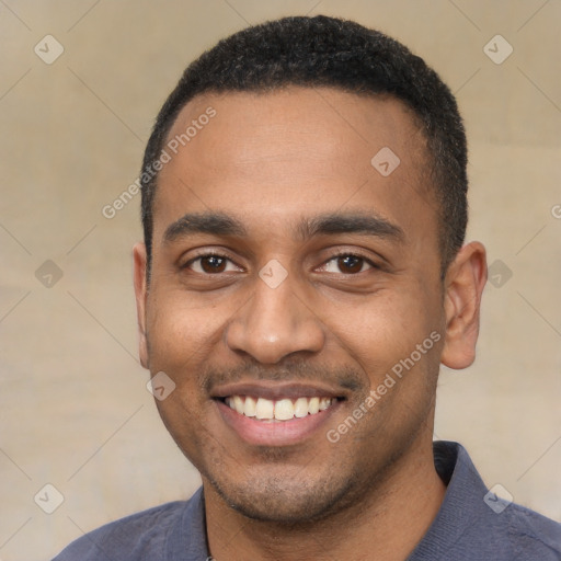 Joyful black young-adult male with short  black hair and brown eyes