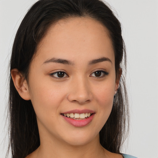 Joyful asian young-adult female with long  brown hair and brown eyes