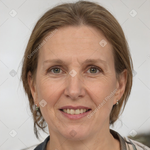 Joyful white adult female with medium  brown hair and grey eyes