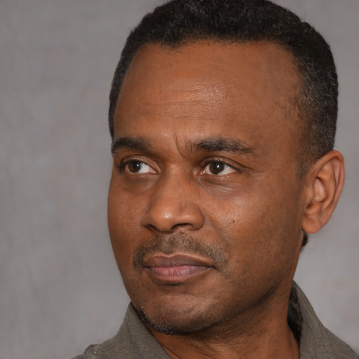 Neutral black adult male with short  black hair and brown eyes