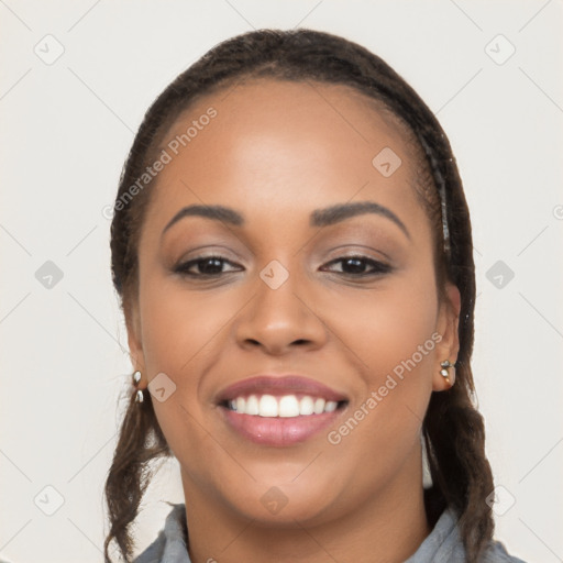 Joyful latino young-adult female with long  black hair and brown eyes