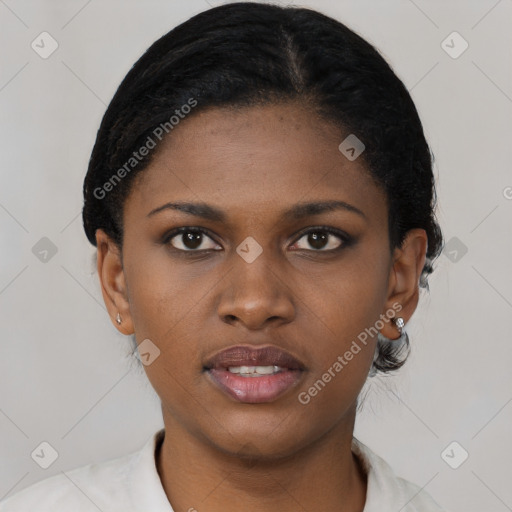 Joyful black young-adult female with short  black hair and brown eyes