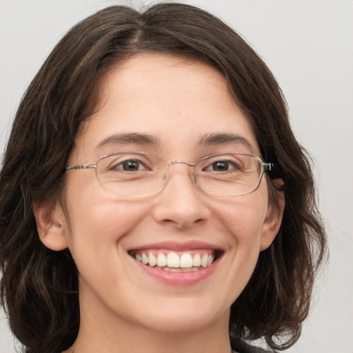 Joyful white adult female with medium  brown hair and grey eyes