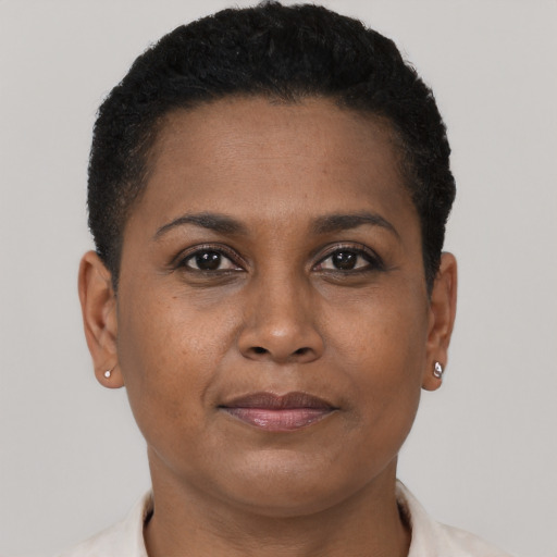 Joyful black young-adult female with short  brown hair and brown eyes