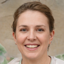 Joyful white adult female with short  brown hair and grey eyes