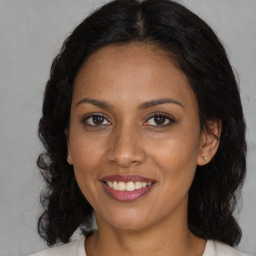 Joyful black young-adult female with medium  brown hair and brown eyes