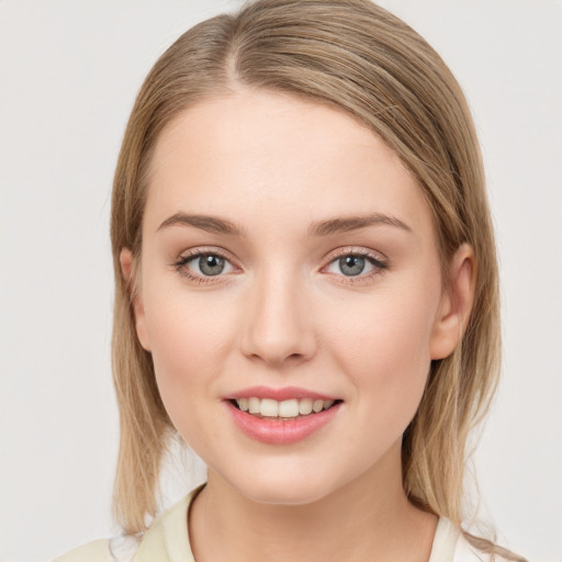 Joyful white young-adult female with medium  brown hair and green eyes