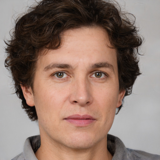 Joyful white adult male with medium  brown hair and brown eyes