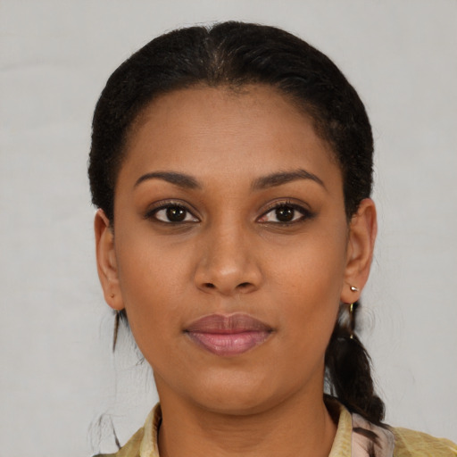 Joyful black young-adult female with short  brown hair and brown eyes