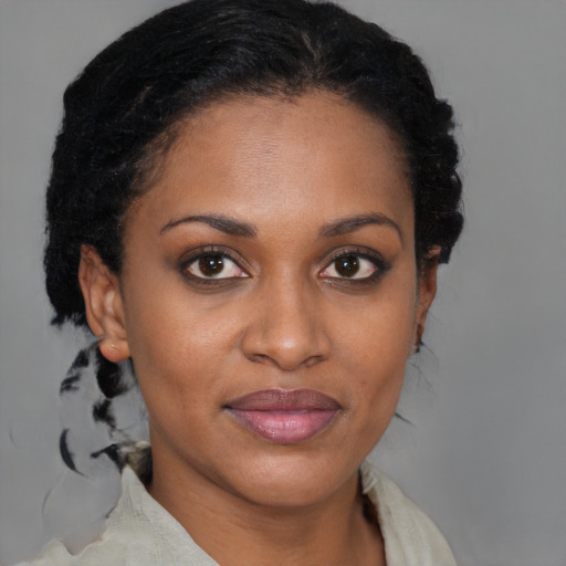 Joyful black young-adult female with short  brown hair and brown eyes