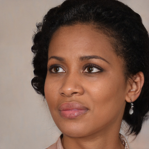 Joyful black young-adult female with medium  black hair and brown eyes