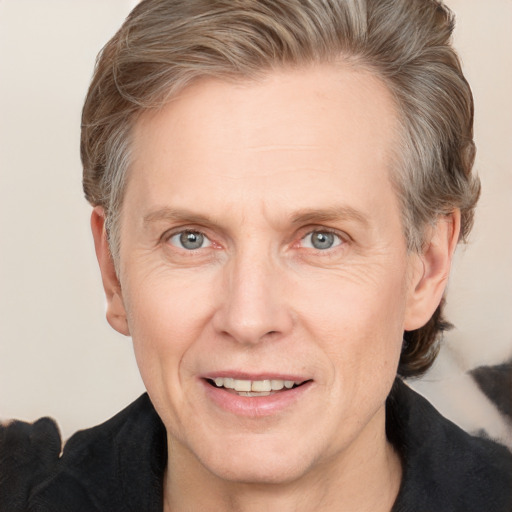 Joyful white adult male with medium  brown hair and grey eyes