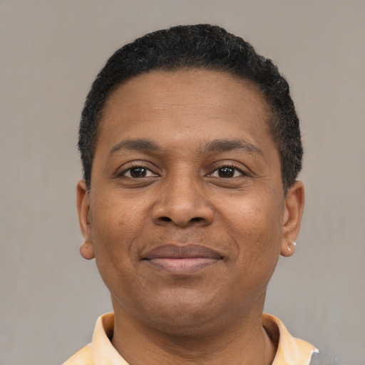 Joyful latino young-adult male with short  brown hair and brown eyes