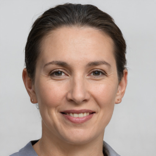 Joyful white adult female with short  brown hair and brown eyes