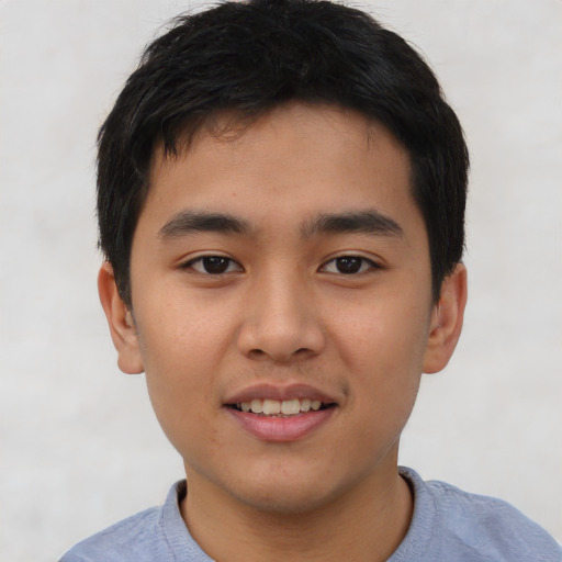 Joyful asian child male with short  black hair and brown eyes