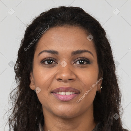 Joyful black young-adult female with long  brown hair and brown eyes
