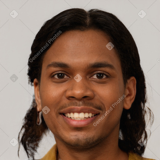 Joyful black young-adult male with short  brown hair and brown eyes