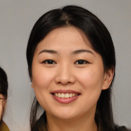 Joyful asian young-adult female with medium  brown hair and brown eyes