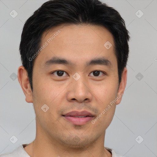 Joyful asian young-adult male with short  black hair and brown eyes