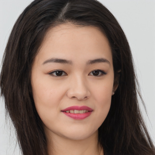 Joyful asian young-adult female with long  brown hair and brown eyes
