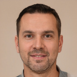 Joyful white adult male with short  brown hair and brown eyes