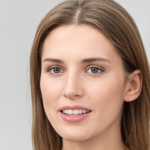 Joyful white young-adult female with long  brown hair and grey eyes