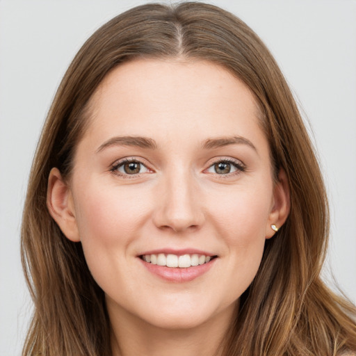 Joyful white young-adult female with long  brown hair and grey eyes