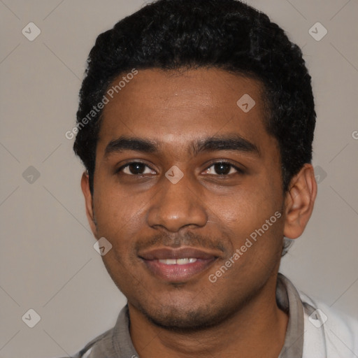 Joyful black young-adult male with short  black hair and brown eyes