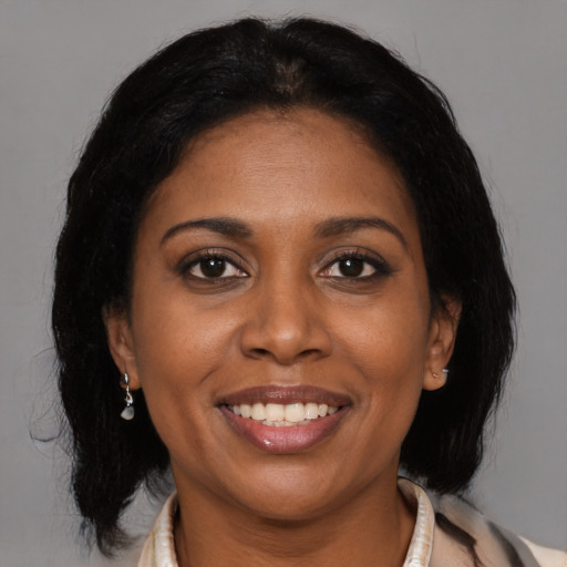 Joyful black young-adult female with medium  brown hair and brown eyes