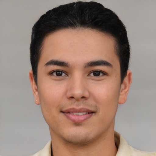 Joyful latino young-adult male with short  brown hair and brown eyes