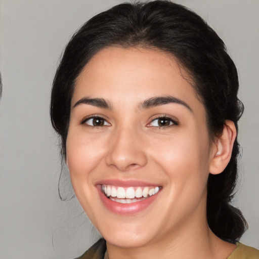 Joyful white young-adult female with medium  black hair and brown eyes