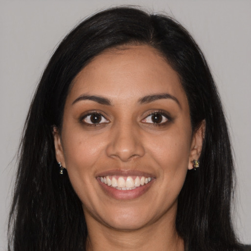 Joyful latino young-adult female with long  black hair and brown eyes