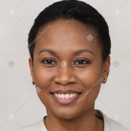 Joyful black young-adult female with short  brown hair and brown eyes