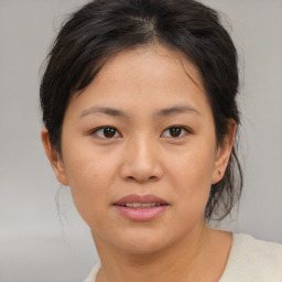 Joyful asian young-adult female with medium  brown hair and brown eyes