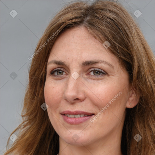 Joyful white adult female with long  brown hair and brown eyes