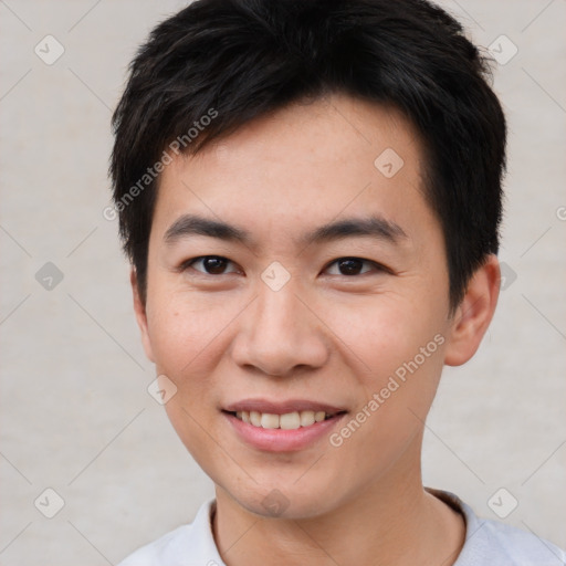 Joyful asian young-adult male with short  brown hair and brown eyes