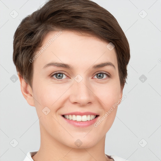 Joyful white young-adult female with short  brown hair and grey eyes