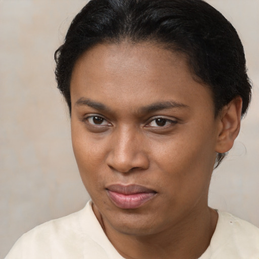 Joyful black young-adult female with short  brown hair and brown eyes