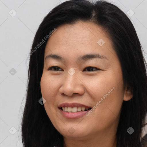 Joyful asian young-adult female with long  brown hair and brown eyes