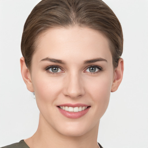 Joyful white young-adult female with short  brown hair and grey eyes