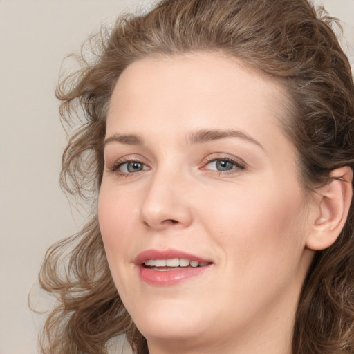 Joyful white young-adult female with medium  brown hair and green eyes