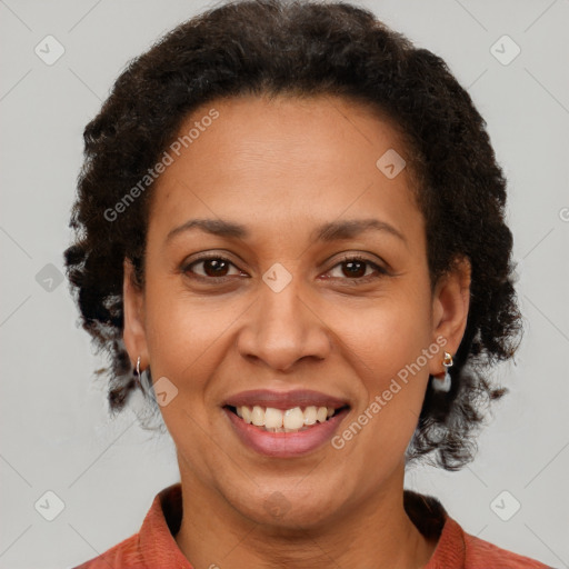 Joyful black adult female with short  brown hair and brown eyes