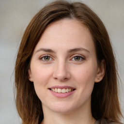 Joyful white young-adult female with medium  brown hair and green eyes