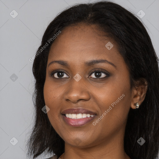 Joyful black young-adult female with long  black hair and brown eyes