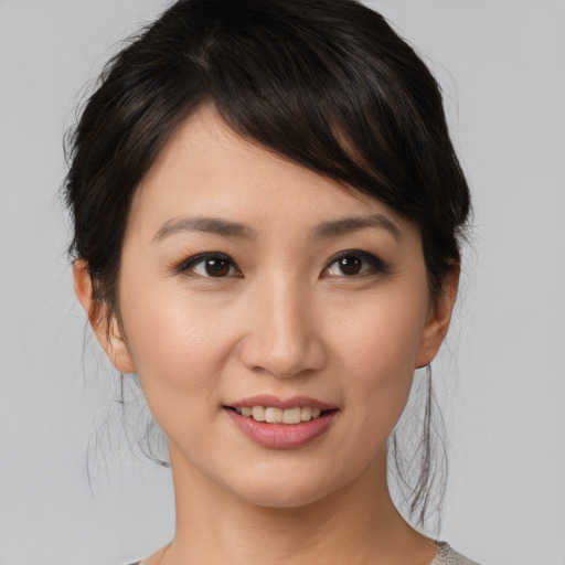 Joyful asian young-adult female with medium  brown hair and brown eyes