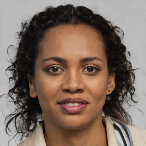 Joyful black young-adult female with long  brown hair and brown eyes
