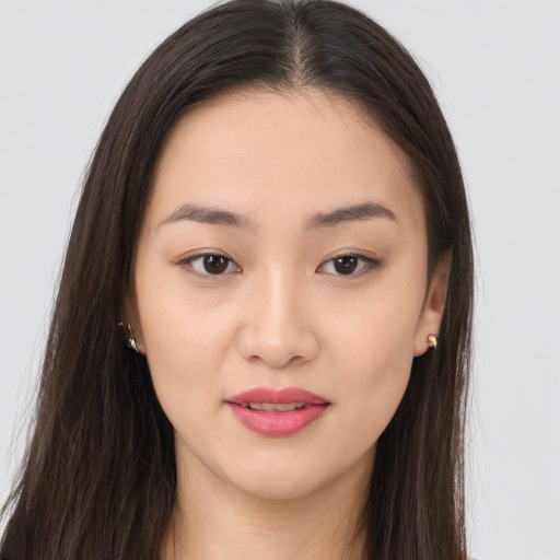 Joyful asian young-adult female with long  brown hair and brown eyes