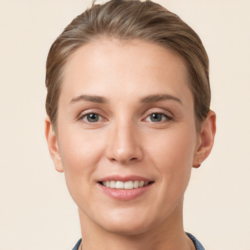 Joyful white young-adult female with short  brown hair and grey eyes