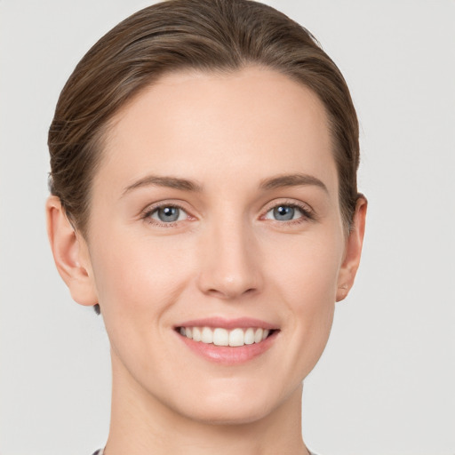 Joyful white young-adult female with short  brown hair and grey eyes